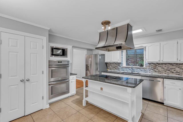 kitchen with ornamental molding, stainless steel appliances, island range hood, sink, and white cabinets