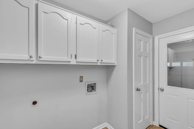 washroom with cabinets, hookup for a washing machine, and hookup for an electric dryer