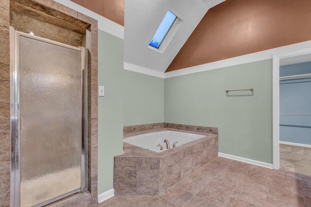 bathroom with tile patterned floors, lofted ceiling with skylight, and independent shower and bath