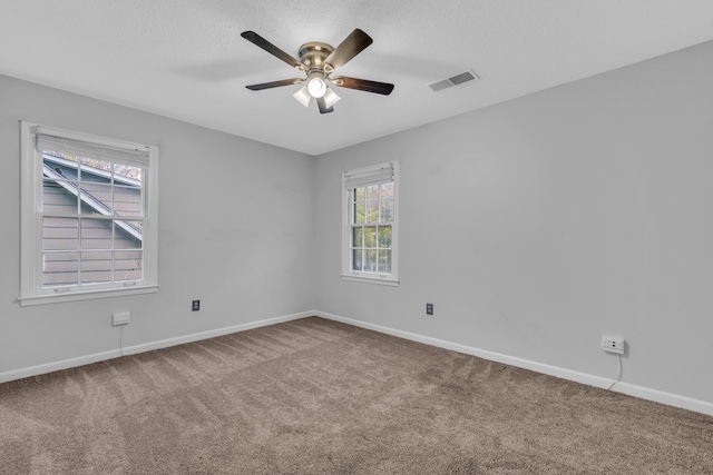 spare room with carpet flooring and ceiling fan