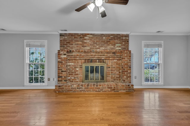 unfurnished living room featuring crown molding, a healthy amount of sunlight, and light wood-type flooring