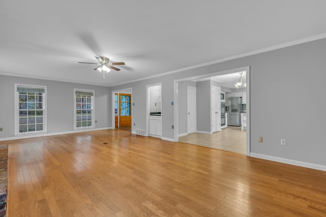 unfurnished living room featuring light hardwood / wood-style flooring, ceiling fan with notable chandelier, and ornamental molding