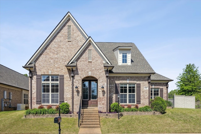 view of front facade with a front lawn and french doors