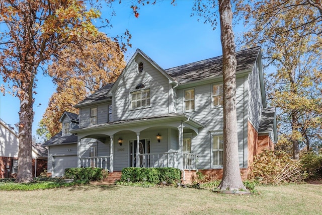 view of front facade featuring covered porch and a front yard