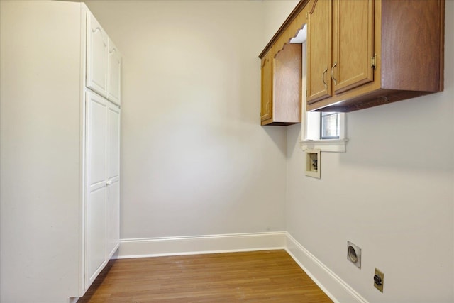 laundry room featuring hookup for an electric dryer, light hardwood / wood-style floors, cabinets, and hookup for a washing machine