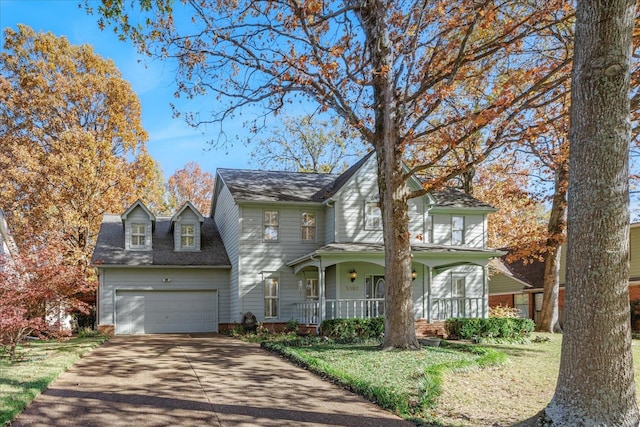 view of front property with a front yard, a porch, and a garage