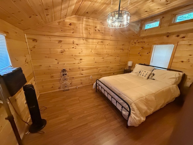 bedroom with hardwood / wood-style floors, wood walls, lofted ceiling, and wood ceiling