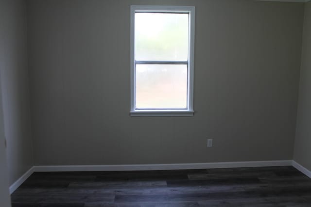 empty room with dark wood-type flooring