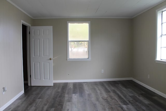 unfurnished room featuring dark hardwood / wood-style floors, a healthy amount of sunlight, and crown molding