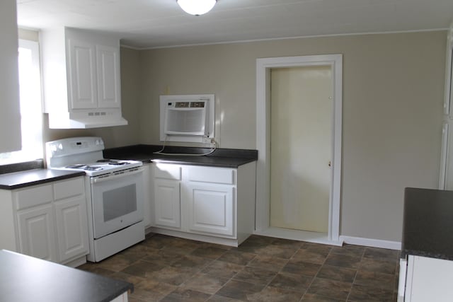 kitchen with electric range, white cabinets, ventilation hood, and a wall mounted AC