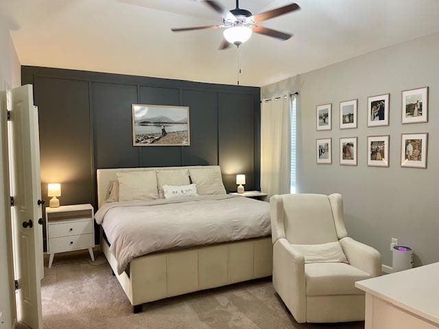 bedroom with ceiling fan and light carpet