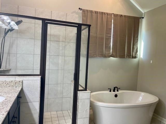 bathroom with separate shower and tub, vanity, and lofted ceiling