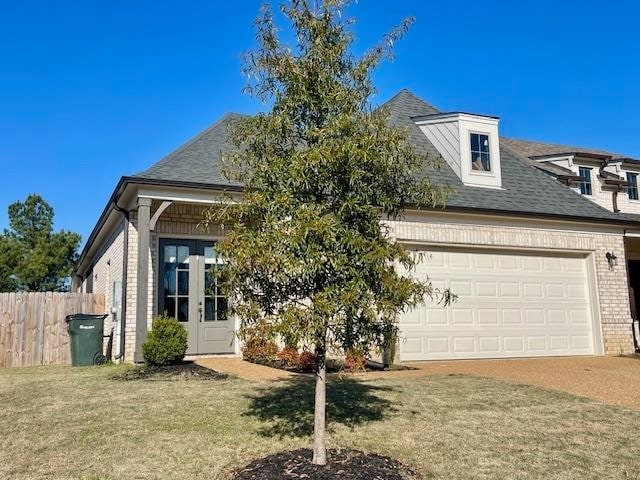 view of front of property featuring a garage and a front yard