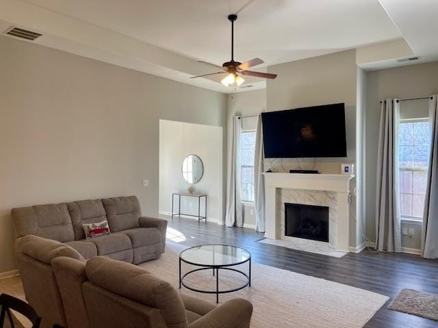 living room featuring a tile fireplace, hardwood / wood-style flooring, and a wealth of natural light