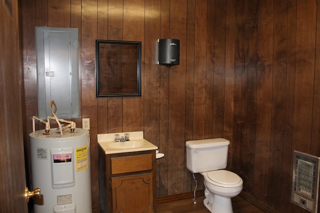 bathroom with vanity, heating unit, water heater, electric panel, and toilet