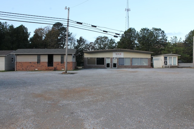 single story home featuring a storage shed