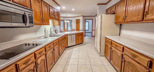 kitchen featuring crown molding, sink, appliances with stainless steel finishes, light tile patterned flooring, and a chandelier