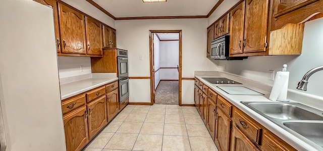 kitchen featuring light tile patterned flooring, crown molding, sink, and stainless steel appliances