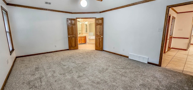 unfurnished bedroom featuring light carpet and crown molding