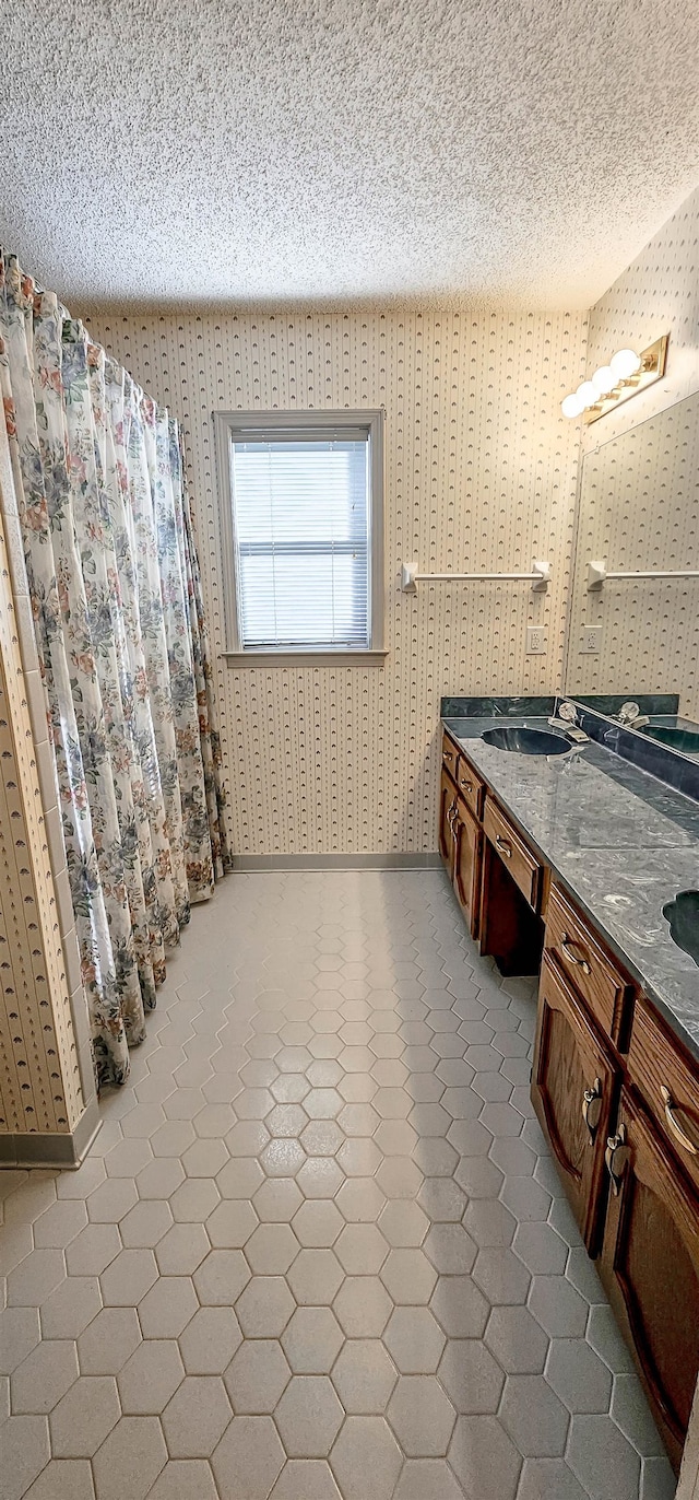 bathroom with vanity and a textured ceiling