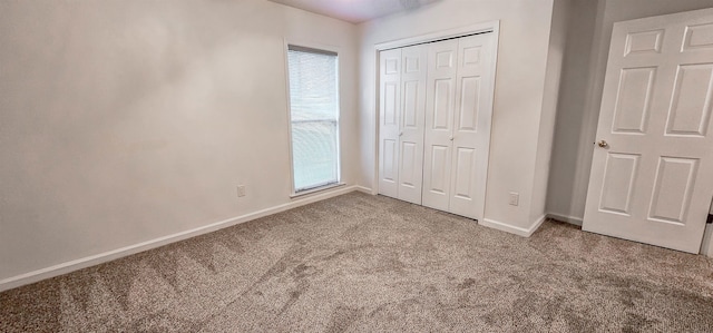 unfurnished bedroom with carpet and a closet