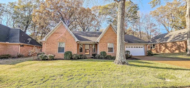 view of front of house with a garage and a front lawn