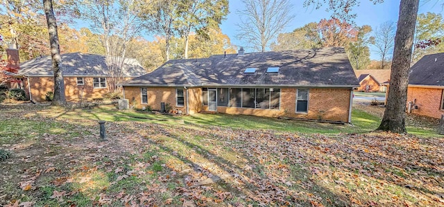 rear view of house featuring a lawn