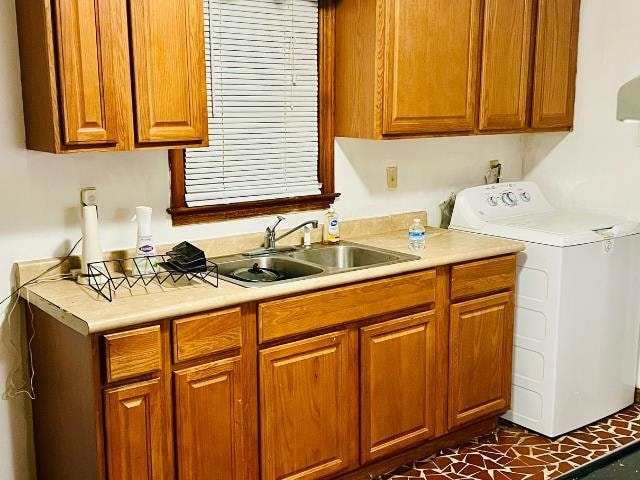 kitchen featuring washer / clothes dryer and sink