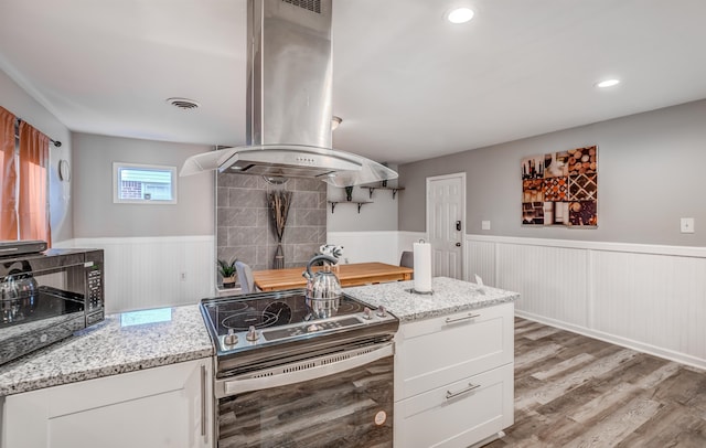 kitchen with white cabinets, ventilation hood, stainless steel electric range oven, light hardwood / wood-style floors, and light stone counters