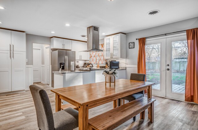 4493 Quince Rd, Memphis, TN 38117 - dining room with light wood-style floors, french doors, recessed lighting, wainscoting, and a decorative wall