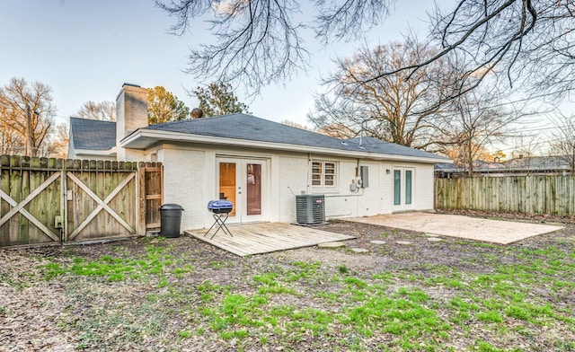 back of property with french doors, a patio, and central AC unit