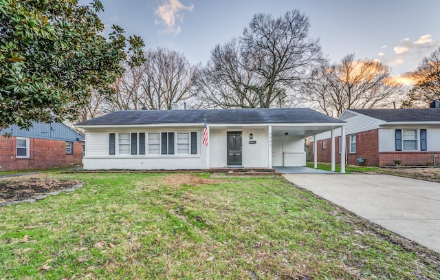 ranch-style house with a yard and a carport