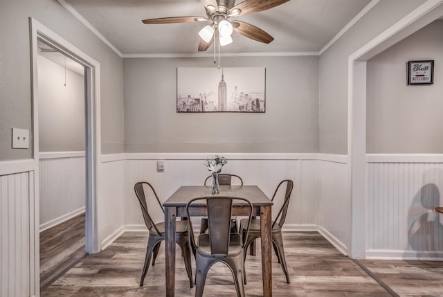 dining room featuring ceiling fan, wood-type flooring, and crown molding