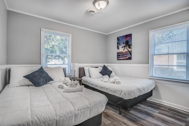 bedroom featuring hardwood / wood-style floors and crown molding