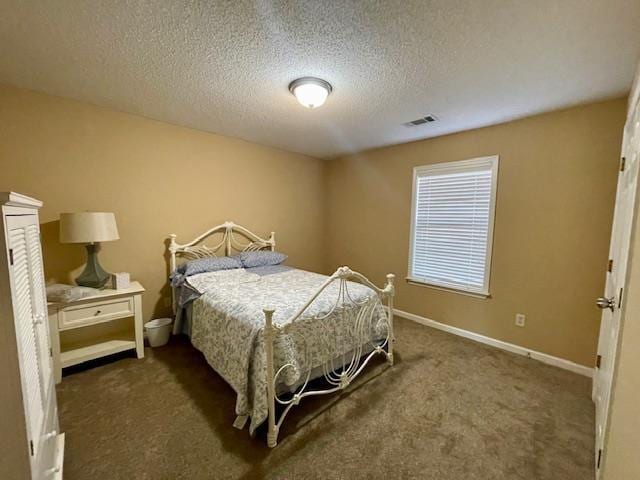 carpeted bedroom featuring a textured ceiling