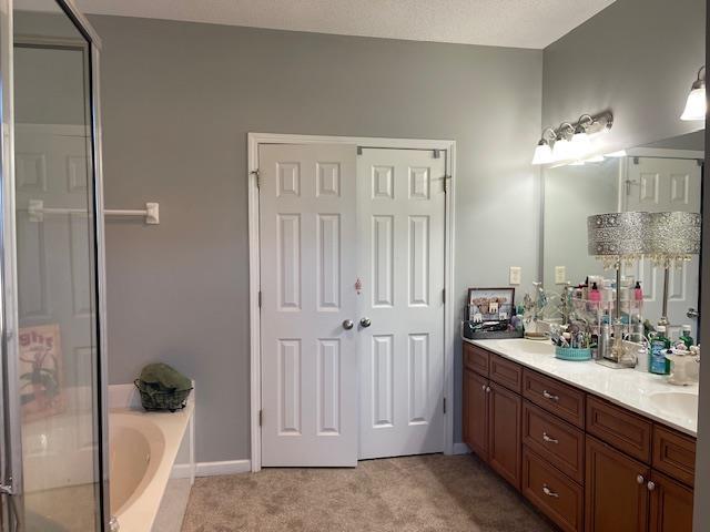 bathroom featuring a washtub and vanity