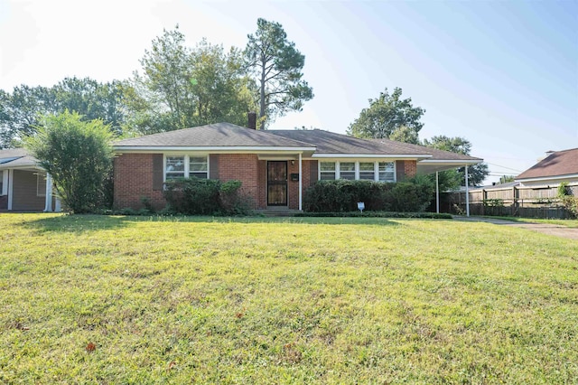 single story home featuring a front lawn and a carport