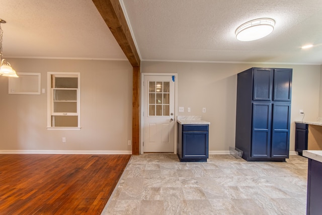 kitchen with a textured ceiling, blue cabinets, decorative light fixtures, beamed ceiling, and light hardwood / wood-style floors