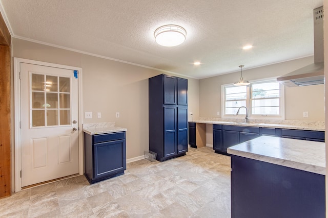 kitchen featuring blue cabinetry, sink, hanging light fixtures, and a textured ceiling