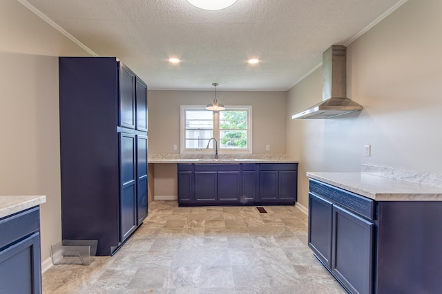 kitchen featuring sink, hanging light fixtures, ornamental molding, and wall chimney range hood