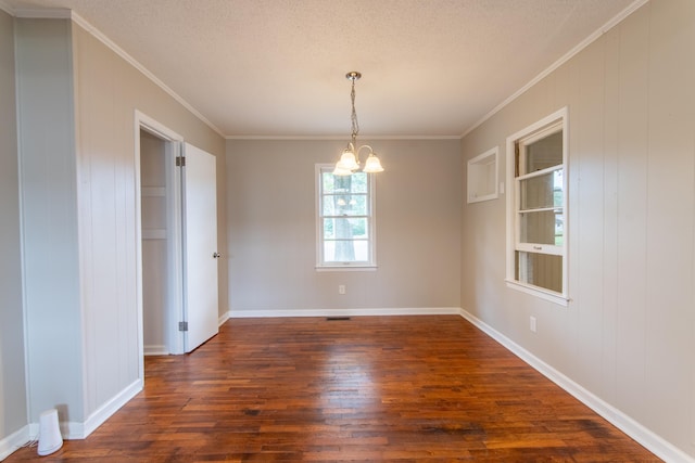 unfurnished dining area featuring ornamental molding, dark hardwood / wood-style flooring, a textured ceiling, and a notable chandelier