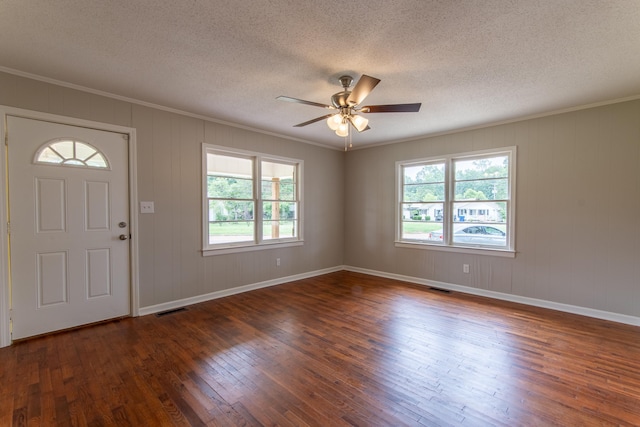 foyer entrance with dark hardwood / wood-style floors, a healthy amount of sunlight, a textured ceiling, and ceiling fan