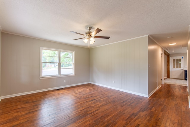 unfurnished room featuring ornamental molding, ceiling fan, and dark wood-type flooring