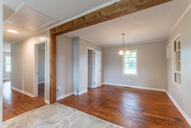 unfurnished room with wood-type flooring, a textured ceiling, plenty of natural light, and crown molding