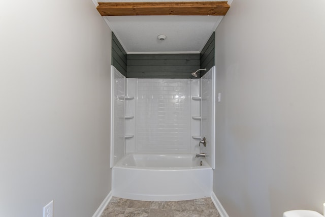 bathroom with tile patterned flooring, a textured ceiling, and shower / washtub combination