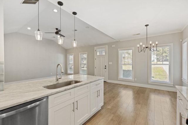 kitchen featuring white cabinetry, dishwasher, light stone counters, and sink