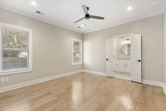 unfurnished bedroom featuring ceiling fan, crown molding, connected bathroom, and light hardwood / wood-style flooring