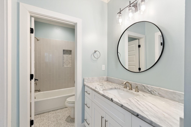 full bathroom featuring tile patterned flooring, vanity, toilet, and tiled shower / bath