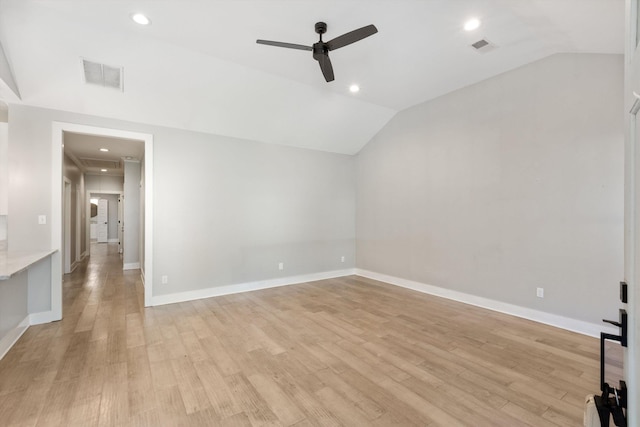 unfurnished room featuring light wood-type flooring and vaulted ceiling