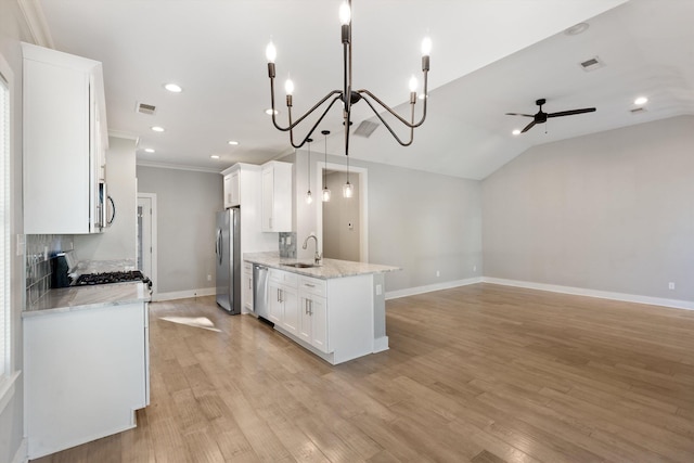 kitchen featuring pendant lighting, white cabinets, sink, light wood-type flooring, and appliances with stainless steel finishes